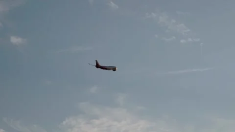 The plane is flying against a background of blue sky and sun Stock Footage 263587030