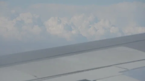 Plane flying, big clouds and wing Stock Footage 22782448