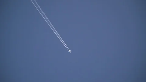 The plane is flying in the blue sky far leaving a trail Vídeo Stock 113226429