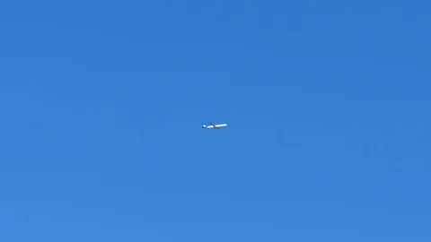 Plane flying in blue sky Stock Footage 116708304