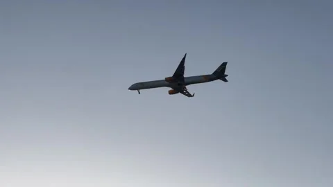 Plane flying in blue sky Stock Footage 337178598