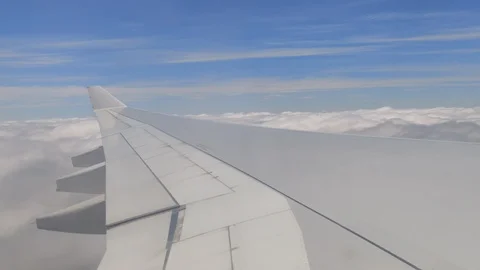 Plane flying up into cloudy blue sky from window perspective, 4K Stock Footage 122662690