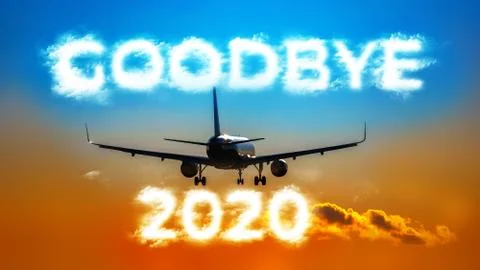 A plane flying into the distance. Cloud-shaped inscription - GOODBYE 2020 Stock Photos
