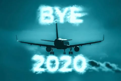 A plane flying into the distance. Cloud-shaped inscription - BYE 2020 Stock Photos