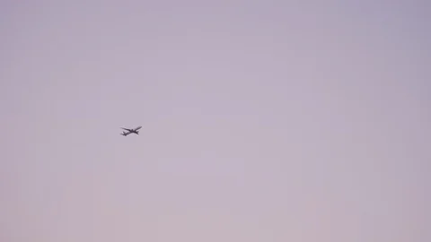 Plane flying during sunset, pink sky. Stock-Footage 107776955