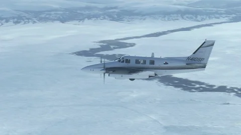 Plane Flying Eye Level With Camera In Snowy Mountains Vídeo Stock 102133780