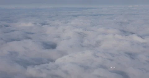 The plane is flying far below the clouds Stock Footage 107138696