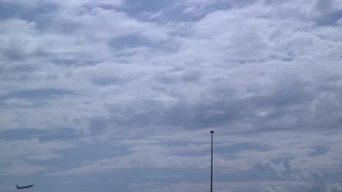 Plane Flying Far On Cloudy Blue Sky Stock Footage 125702617