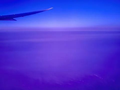 Plane flying high above cloud layer Stock Photos