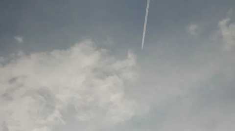 Plane flying at high altitude leaving a condensation sky trail chem trail 4k Stock Footage 45454435