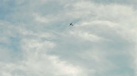 Plane flying high in a cloudy sky Stock Footage 40542977