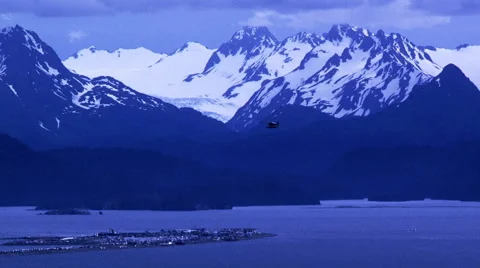 Plane flying  high over  the Alaska's Homer Spit Stock Footage 40454490