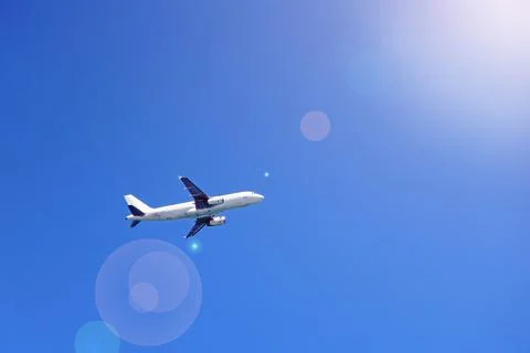 Plane flying high in sky. View to air liner flying in blue sky Stock Photos