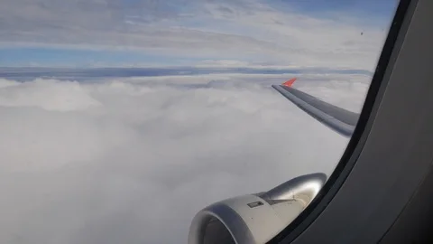 The plane is flying low above the clouds, the view from the passenger seat Stock Footage 123370558