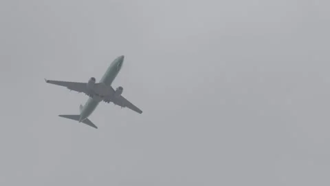 Plane Flying Low to Land Stock Footage 154004814