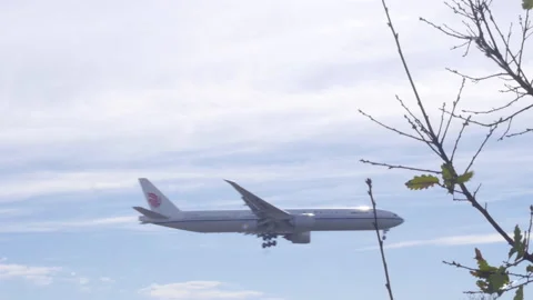 Plane Flying Low Through Frame On Landing Approach Stock-Footage 149155618