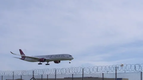 Plane Flying Low Through Frame On Landing Approach Stock-Footage 149254974