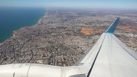 Plane is flying over the big city after takeoff Stock Footage