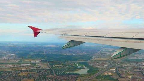 Plane flying over the city Stock Footage 75654755