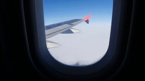 The plane is flying over the clouds view from the plane in the window Stock Footage 123372666