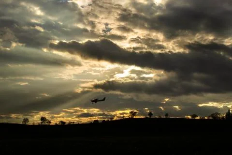 Plane flying over a field Stock Photos