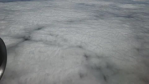 Plane flying over fluffy clouds, window video, pov 库存影片 242452432