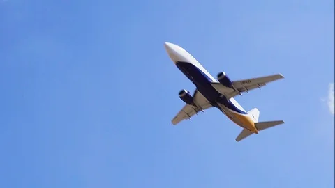 Plane flying over head on blue sky. Airplane takeoff into the sky. Stock Footage 96210125