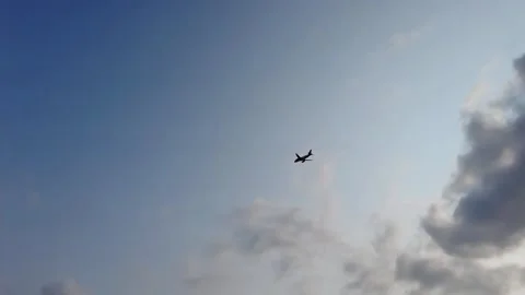 Plane flying over head on blue sky Stock Footage 248115308