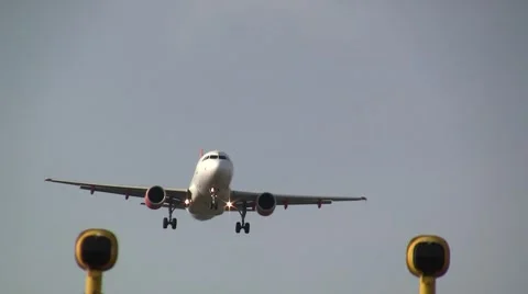 Plane flying over lamppost coming in for landing Stock Footage 4888372