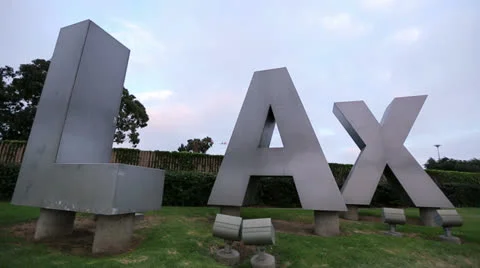 Plane Flying over LAX Sign - Airplane Overhead Flies over Highway with Audio Stock Footage 26388697