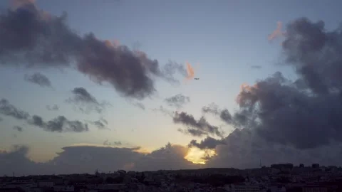 Plane flying over lisbon during sunset Stock Footage 275520667