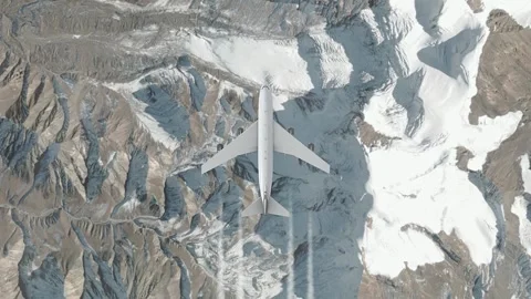 Plane flying over mountainous terrain with snow-capped peaks Stock Footage 325037973