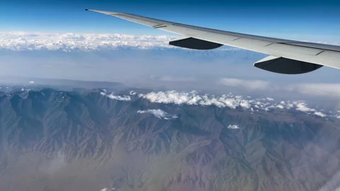 The plane is flying over the mountains 스톡 동영상 239769377