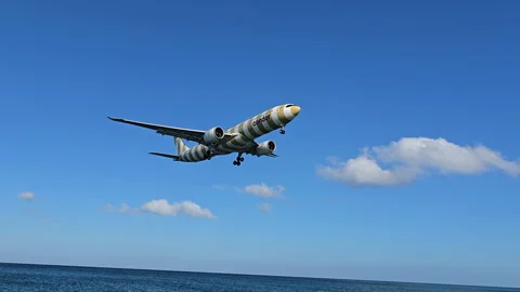 Plane is flying over the ocean Stock Footage 304321805