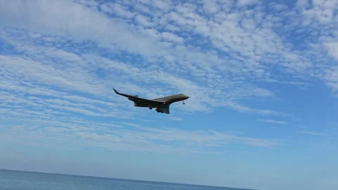 Plane is flying over the ocean Stock Footage 304329122