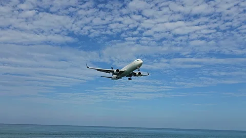 Plane is flying over the ocean Stock Footage 304416342