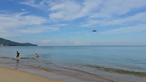 Plane is flying over the ocean Stock Footage 305045103