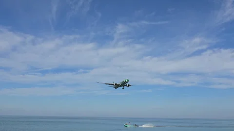 Plane is flying over the ocean Stock Footage 305045733