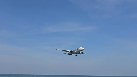 Plane is flying over the ocean Stock Footage 305058110