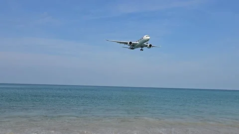 Plane is flying over the ocean Stock Footage 305058733