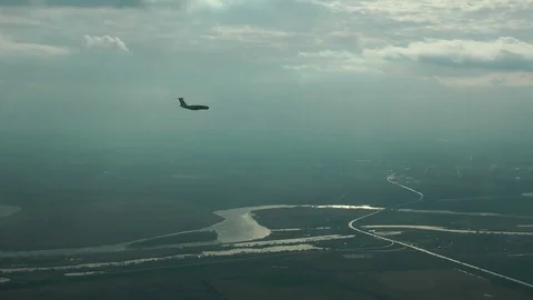 The plane is flying over the river Stock Footage 70653243