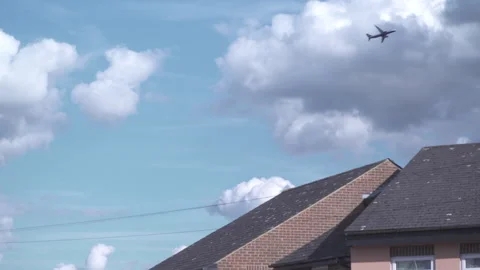 Plane Flying over Roofs in Luton, United Kingdom Stock Footage 293306101
