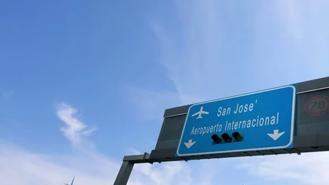 Plane flying over san jose airport sign Stock Footage 82479199