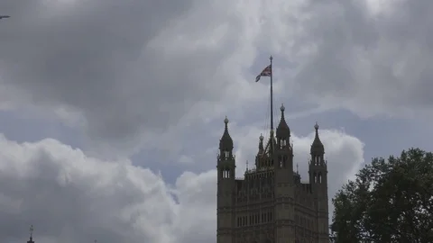 The plane is flying over the tower. Flag of Britain. Stock Footage 76548533