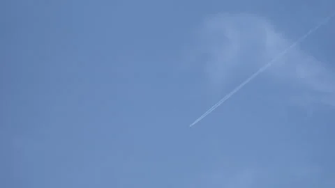 Plane Flying Overhead in a Clear Blue Sky Stock Footage 293305995