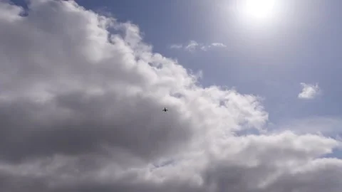 Plane flying overhead with clouds and sun Portland Oregon USA May 2nd 2025 Stock-Footage 307876914