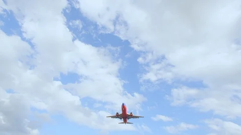 Plane flying overhead as it comes in for a landing Stock Footage 94421227