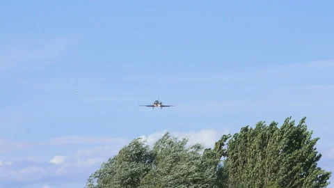 A plane flying overhead as it comes into land at Barcelona - El Prat Airport Stock Footage 121953709