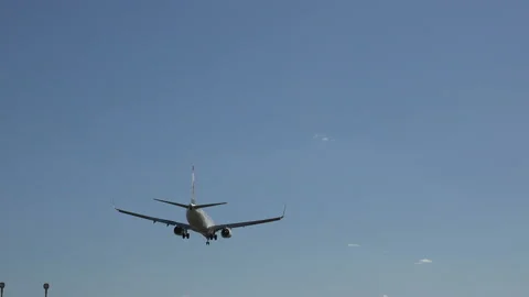 A plane flying overhead as it comes into land at Barcelona - El Prat Airport Stock Footage 121953715