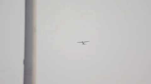 Plane flying by a pole Stock Footage 103868631